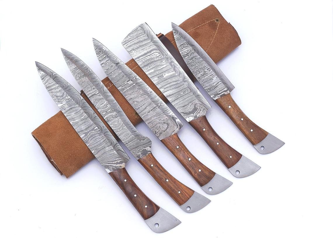 https://forgingblades.com/wp-content/uploads/2021/06/Hand-Forged-Damascus-Chef-Knife-Set-Kitchen-Knife-Set-with-Leather-Roll.jpg